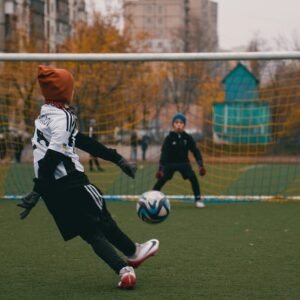 Children playing soccer on a cool autumn day in a park in Kyiv, Ukraine, enjoying outdoor sports.
